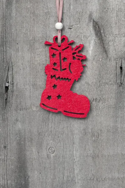 Generic machine made Christmas stocking boot ornament on rustic — Stock Photo, Image