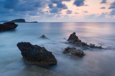 Stunning landscapedawn sunrise with rocky coastline and long exp
