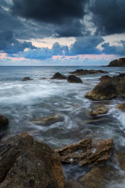 Stunning landscapedawn sunrise with rocky coastline and long exp