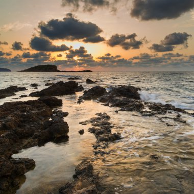 Stunning landscapedawn sunrise with rocky coastline and long exp