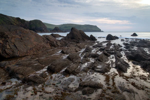 Hope Cove paisagem pôr-do-sol seascape com costa rochosa e lon — Fotografia de Stock