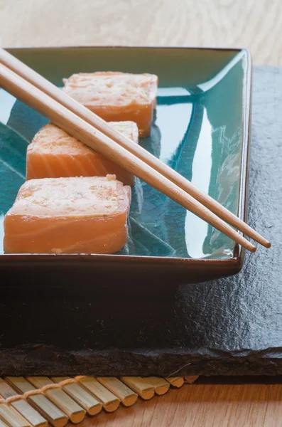 Fresh sushi salmon cream cheese parcels on plate with chopsticks — Stock Photo, Image