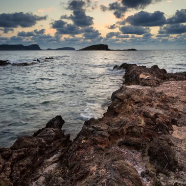 Stunning landscapedawn sunrise with rocky coastline and long exp