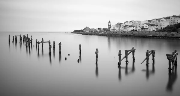 Fine art landscape image of derelict pier in milky long exposure — Stock Photo, Image