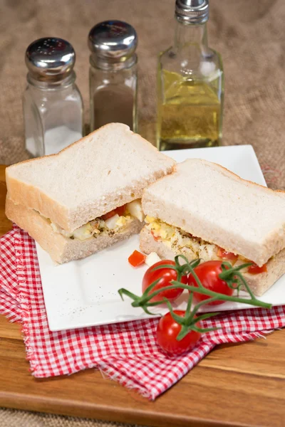 Fresh egg and tomato on white sandwich in rustic kitchen setting — Stock Photo, Image