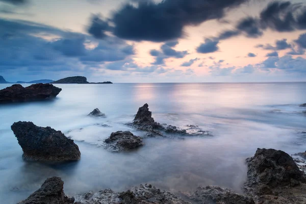 Stunning landscapedawn sunrise with rocky coastline and long exp — Stock Photo, Image