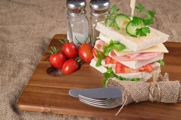 Fresh club sandwich in rustic kitchen setting — Stock Photo, Image