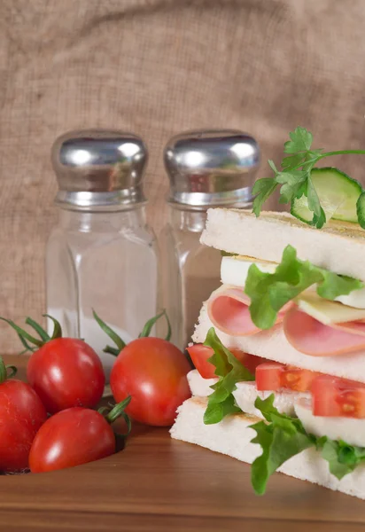 Fresh club sandwich in rustic kitchen setting — Stock Photo, Image