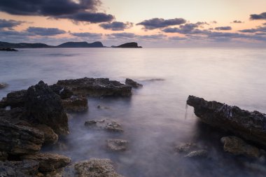Sunrise over rocky coastline on Meditarranean Sea landscape in S clipart