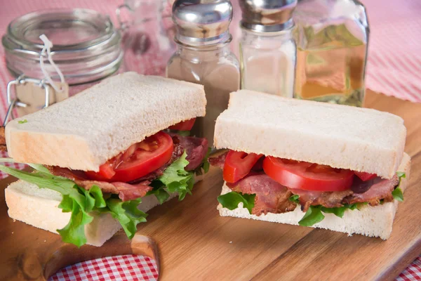 Fresh BLT on white sandwich in rustic kitchen setting — Stock Photo, Image