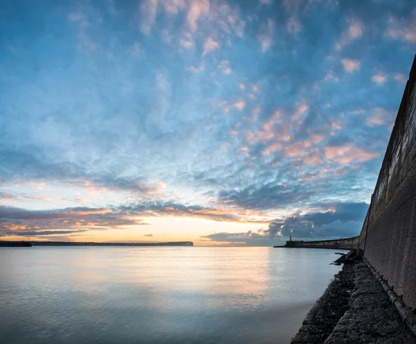 Beautiful vibrant sunrise sky over calm water ocean with lightho — Stock Photo, Image