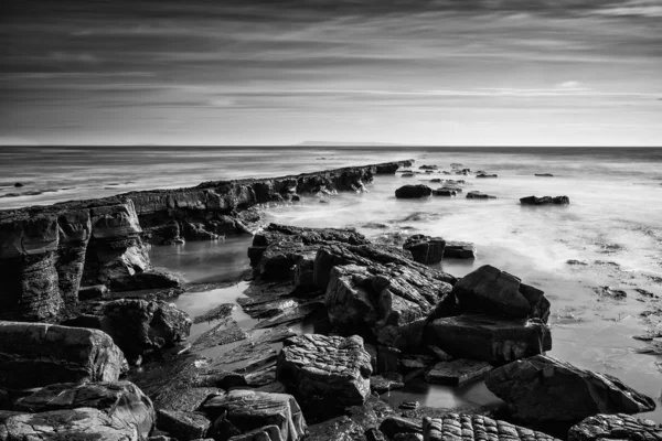 Μαύρο και άσπρο όμορφο τοπίο βραχώδη ακτή στο ηλιοβασίλεμα — Φωτογραφία Αρχείου