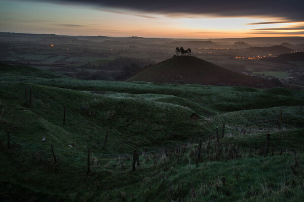 Beautiful sunrise dawn landscape of hills overlooking brightly l