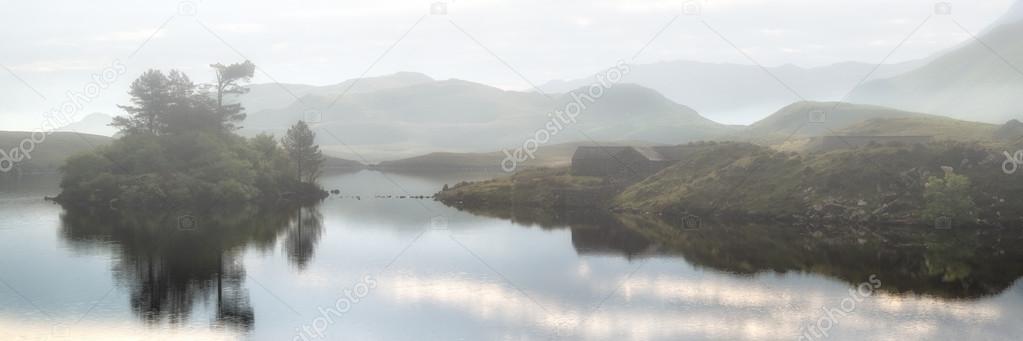 Panorama landscape view of lakein mountains with thick fog hangi