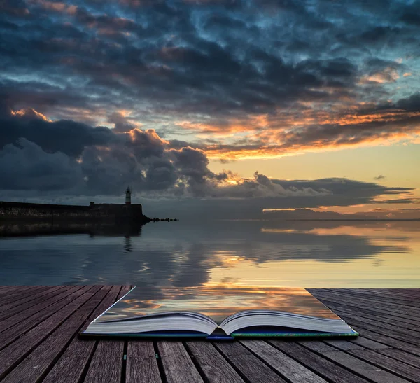 Book concept Beautiful vibrant sunrise sky over calm water ocean — Stock Photo, Image