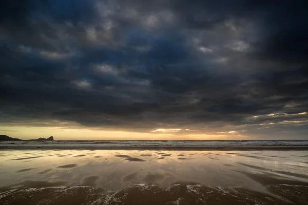 Dramatic stormy sky landscape reflected in low tide water on Rho — Stock Photo, Image