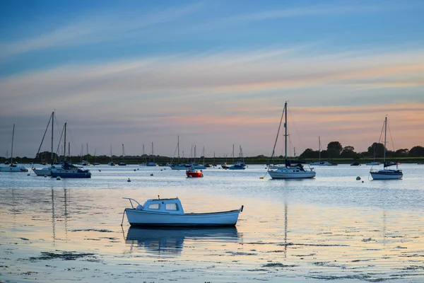 Landscape tranquil harbour at sunset with yachts in low tide — Stock Photo, Image