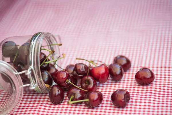 Frasco de armazenamento de vidro cheio de cerejas frescas — Fotografia de Stock