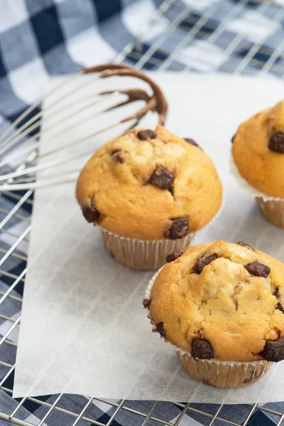 Tasty home made muffins with whisk covered in melting chocolate — Stock Photo, Image