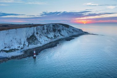 Beautiful Summer sunrise landscape image of Beachy Head Lighthouse in South Downs National Park in England