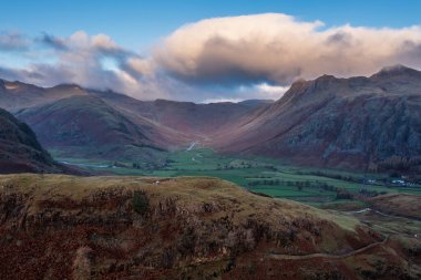 Epic aerial drone landscape image of sunrise from overlooking the Langdale Pikes in Lake District during stunning Autumn 