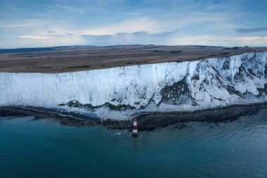 Beautiful Summer sunrise landscape image of Beachy Head Lighthouse in South Downs National Park in England