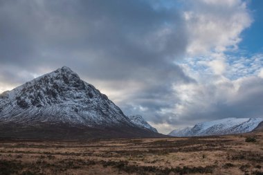 Beautiful Winter landscape image of iconic snowcapped Stob Dearg Buachaille Etive Mor mountain in the background