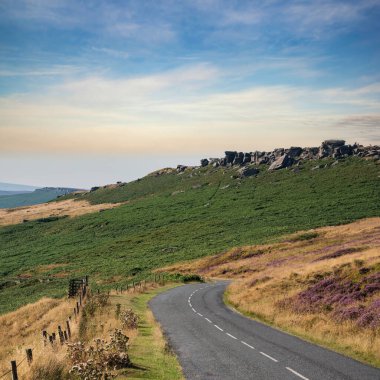 Beautiful landscape image in late Summer of Stanage Edge in Peak District England with stunning clouds formations