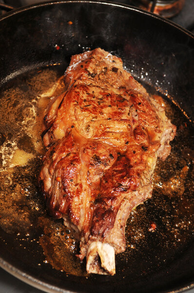 Tasty steak closeup in cast iron frying pan