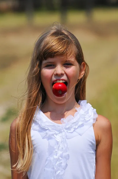 Funny portrait with apple in mouth — Stock Photo, Image