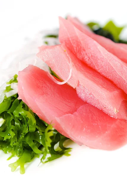 Pieces of tuna and salad on white — Stockfoto