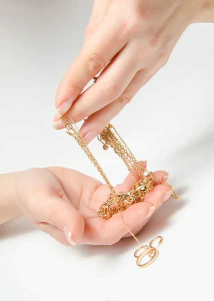 Gold ornaments in a hand — Stock Photo, Image