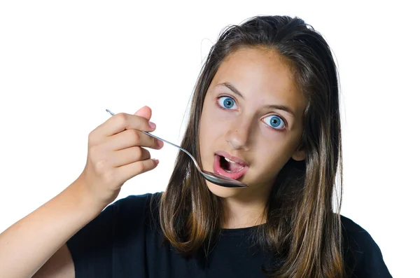 Chica adolescente con cuchara en la boca. Aislado sobre blanco — Foto de Stock