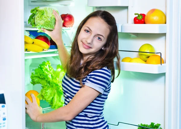 Beautiful Young girl near the Refrigerator with healthy food — Stock Photo, Image