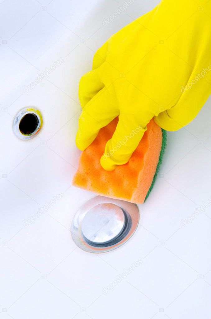 Woman doing chores in bathroom at home, cleaning sink and faucet with spray detergent