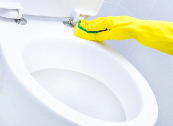 Mains sur les gants jaunes nettoyage d'un WC — Photo