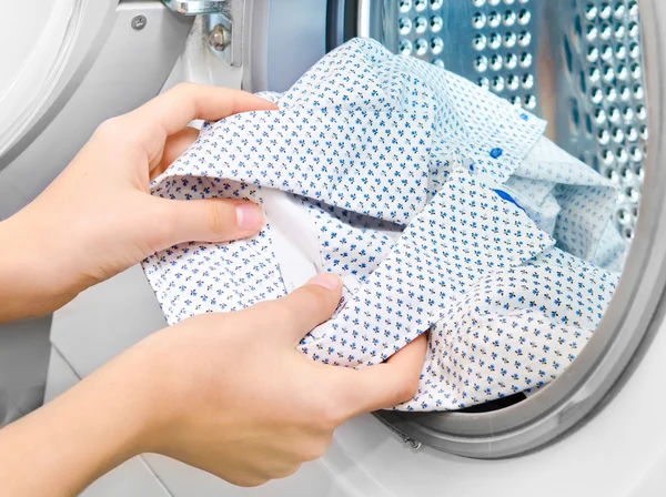 Housework: young woman doing laundry — Stock Photo, Image