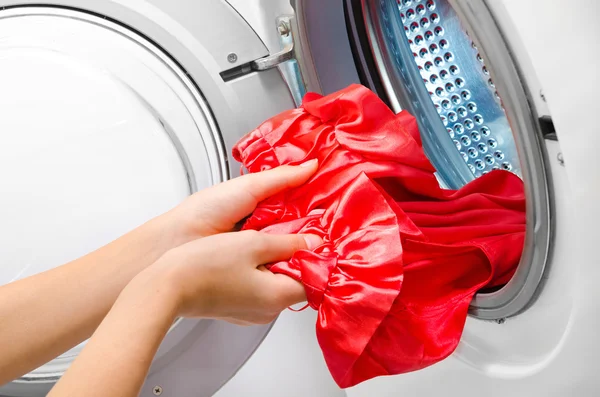 Housework: young woman doing laundry — Stock Photo, Image