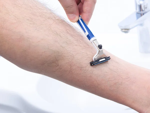 Shaving legs in bathroom — Stock Photo, Image