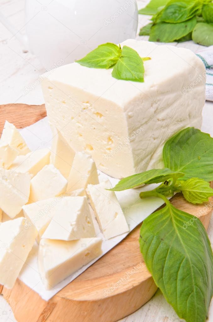 Feta cheese on wooden board.