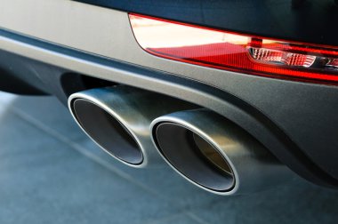 Close up of a car dual exhaust pipe clipart