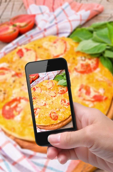 Hands taking photo pizza with smartphone — Stock Photo, Image