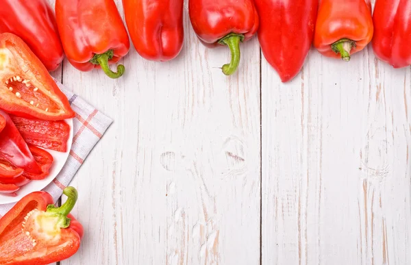 Red peppers on white wooden table. Frame. — Stock Photo, Image