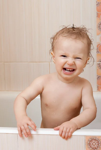 Dissatisfied baby in the bathroom — Stock Photo, Image