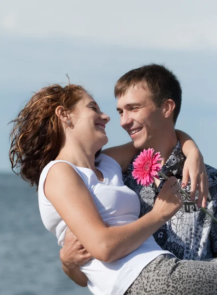 Man is holding his wife on hands outdoors — Stock Photo, Image