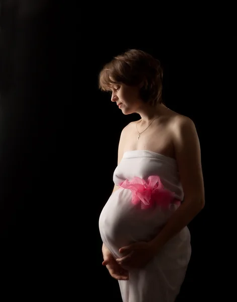 Femme enceinte sur le fond sombre — Photo