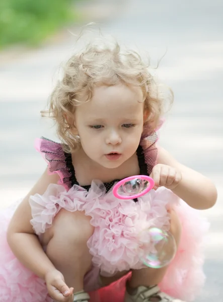 Chica está soplando burbujas de jabón — Foto de Stock