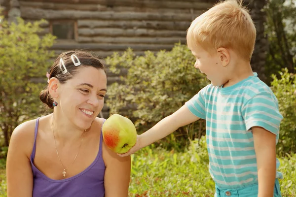 Woman and boy with the apple — Stock Photo, Image