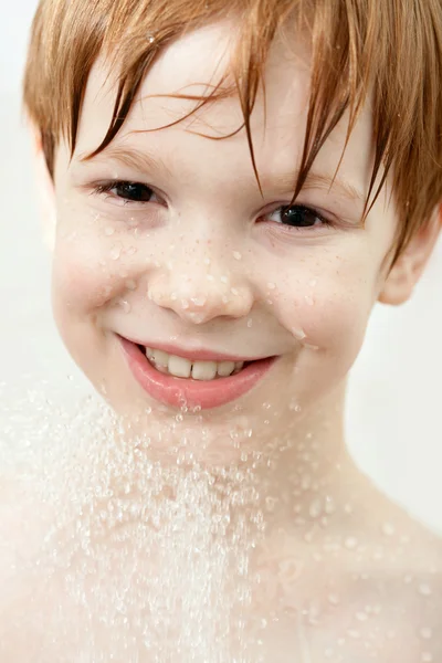 Boy in sprays of water — Stock Photo, Image