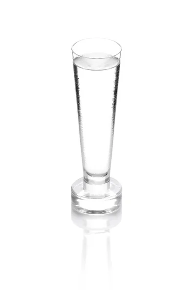 Shot glass filled with clear cold alcohol isolated on white — Stock Photo, Image